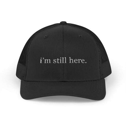 “i’m still here.” – Minimalist Trucker Hat